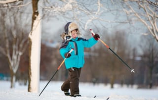 Small child cross country skiing.