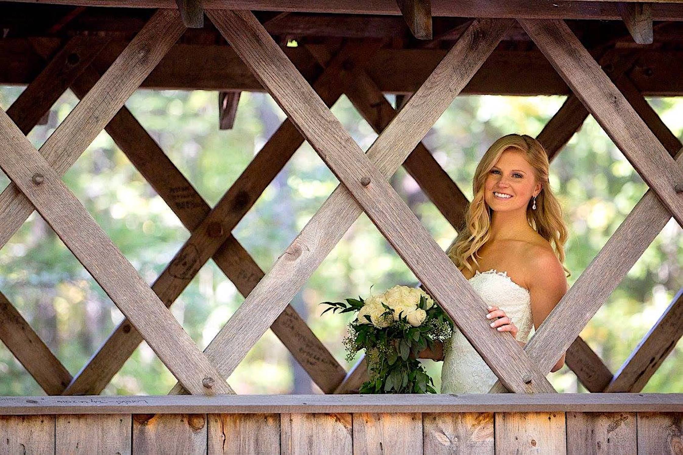 Bride standing in the covered bridge.