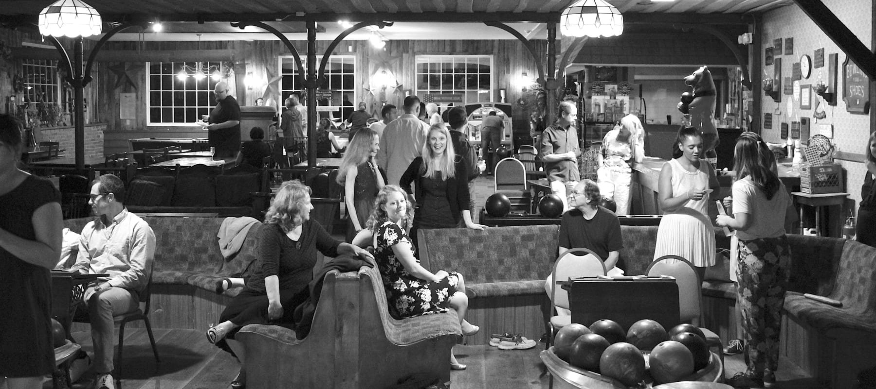 Black & White photo of people at the bar and lounge area.