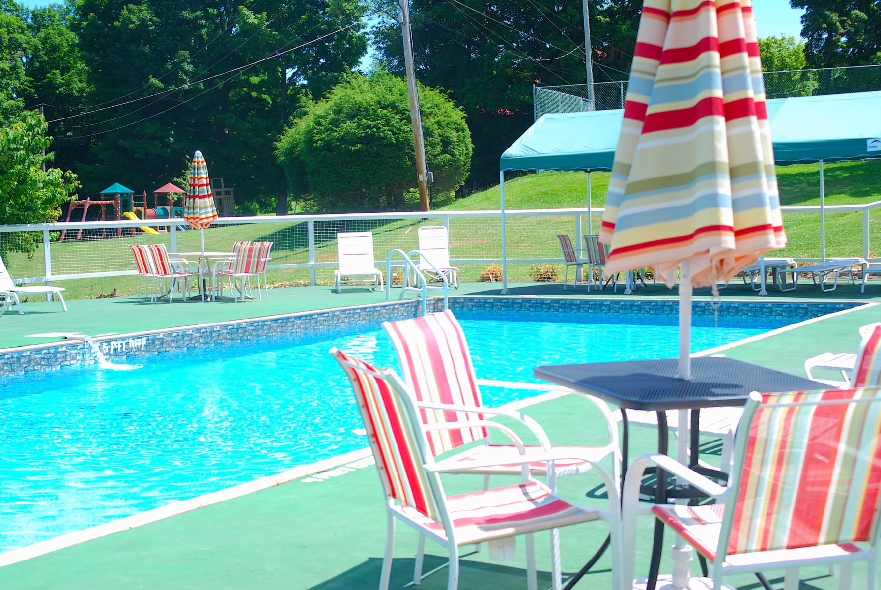 Outdoor pool, lounge chairs and tables.