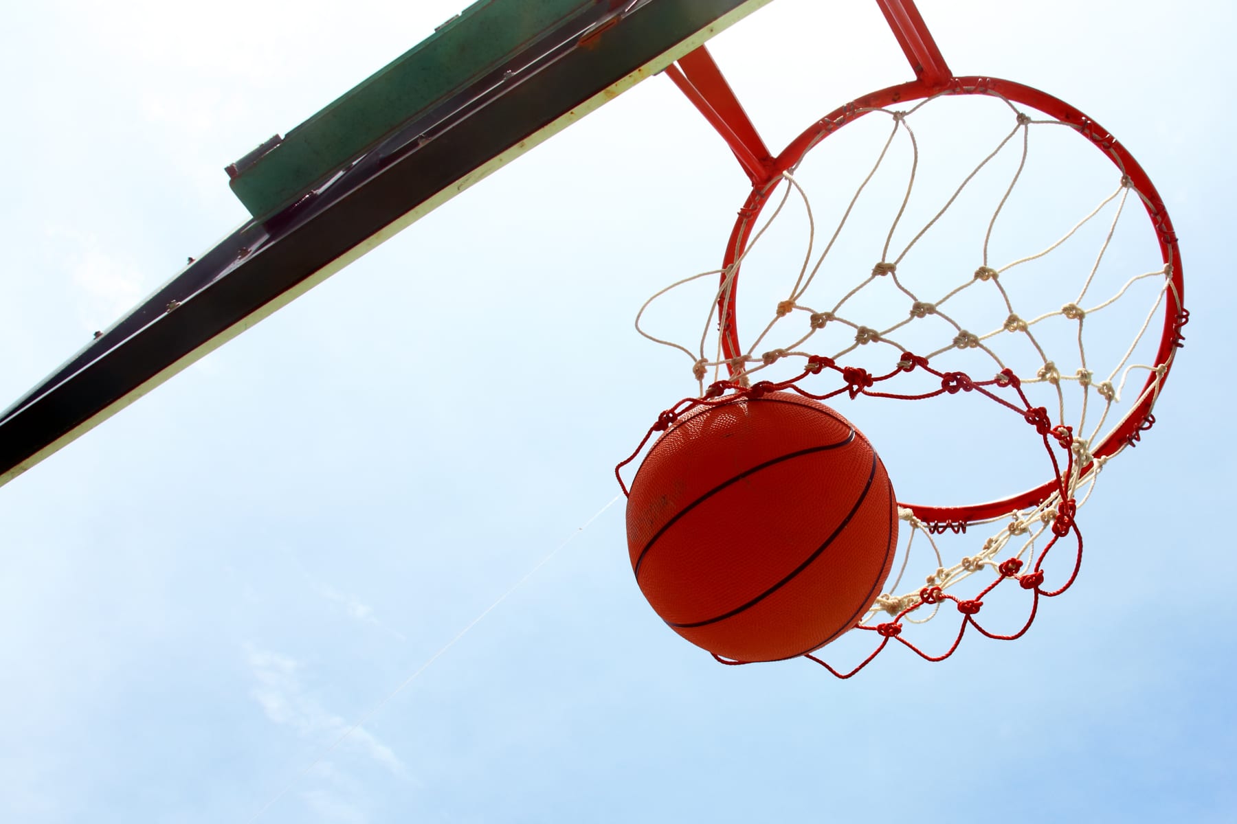 Basketball going through a hoop.