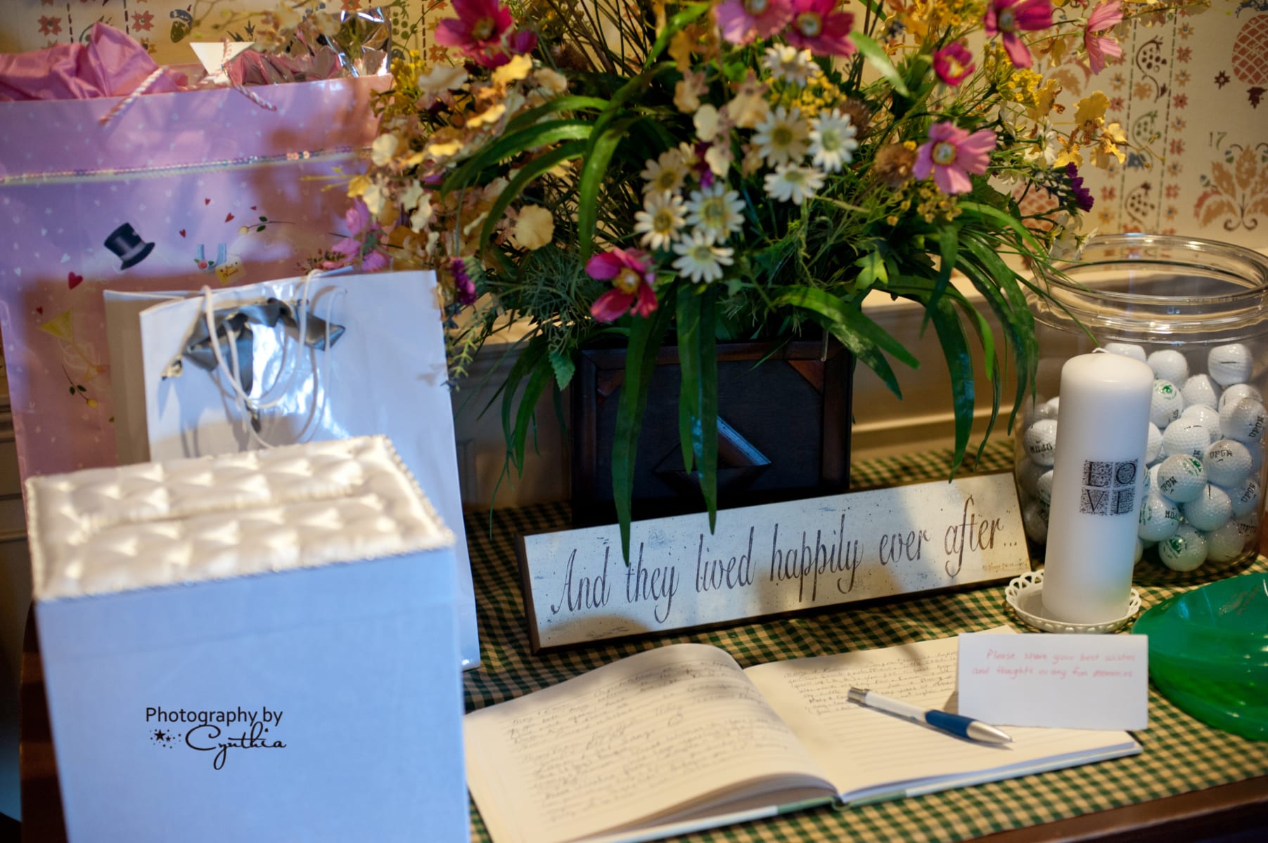 Wedding guest book, candle, flowers and card box.
