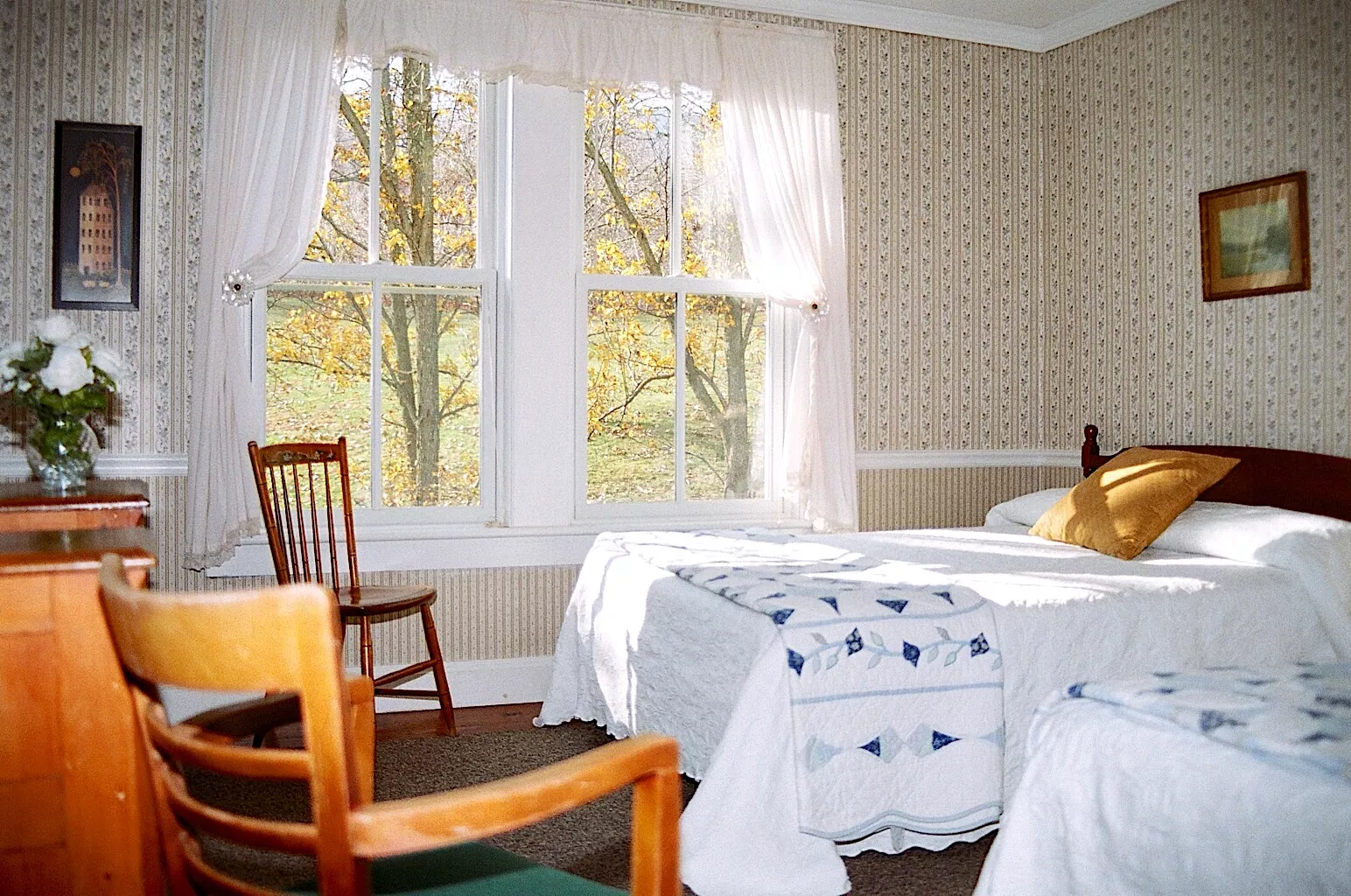 Winter Clove Inn bedroom Victorian style bedroom with two beds and wallpaper.